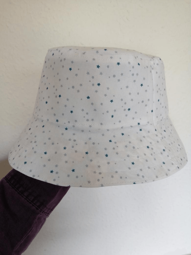 Hat - approx. 2-4 yrs.   Light blue cows